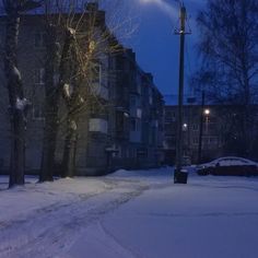 a street light in the middle of a snowy road