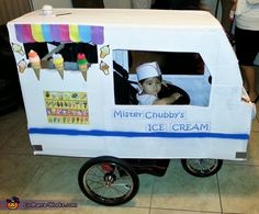 a small ice cream cart with a baby in it