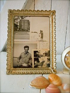 an old photo is hanging on the wall next to shells