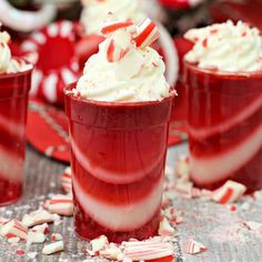 red drinks with candy canes and whipped cream