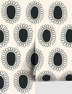 the black and white wall paper has an oval design on it