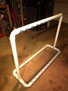 a white pipe frame sitting on top of a floor