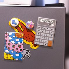 an office cubicle with magnets, paper and calculator