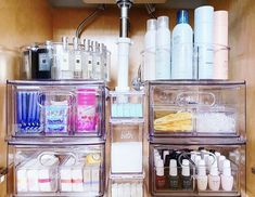 an organized bathroom cabinet with lots of beauty products on it's shelves and drawers