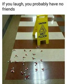 a caution sign sitting on top of a floor next to candy candies in front of it