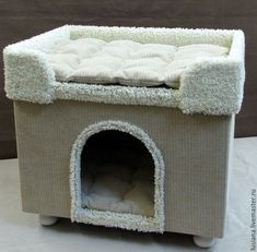 a cat bed made out of fabric with a dog house on it's side