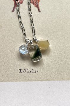 The Dainty chlorite charm inclusion has an amazing geometry formation of a green phantom-like formation with a triangle shape. Making this ultra-modern piece that is unlike the other crystal charms.  With a macro lens or your iphone zoom lens, you will see there is a light shimmer on the inclusions, which is due to tiny air pockets deposited during the crystal growth/crystal formation.  Materials + Measurement | approx. 0.9m (L) x 1.8cm (H)  x 0.6cm (W) | 1.5g Sterling Silver | S925 Stamp You will receive the exact item you selected shown in the video/picture. This listing is for one Pendant. Add on the necklace with customised length here https://www.etsy.com/listing/1491048361 All our shipping arrangements are with tracking. Free shipping with purchases over USD180 a single receipt. To s Green Spiritual Jewelry With Natural Inclusions, Spiritual Green Jewelry With Natural Inclusions, Minimalist Green Moss Agate Jewelry, Modern Green Drop Jewelry, Unique Green Necklace With Natural Inclusions, Crystal Growth, Garden Quartz, Crystal Formations, Be Natural