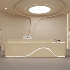 a white reception desk in an office with circular lights and artwork on the wall behind it