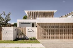 a white house with wooden slats on the front