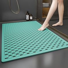 a person is standing on a shower mat