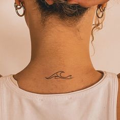 a woman with a tattoo on her neck