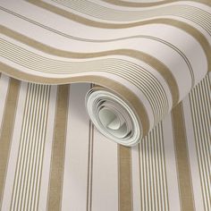 a close up view of a wallpaper with stripes in beige and white color scheme