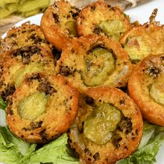 some food is on a white plate with lettuce and other foods around it