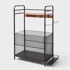 a black cart with two drawers and a wooden shelf on the top, in front of a white background