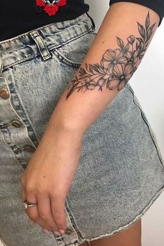 a woman with a flower tattoo on her arm