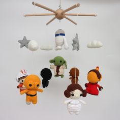 crocheted stuffed animals are hanging from the ceiling in front of a white background