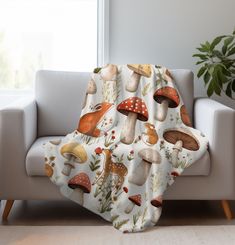 a couch with a blanket that has mushrooms on it