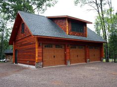 a two car garage in front of a wooded area