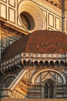 an ornate building with a clock on the front and side of it's face