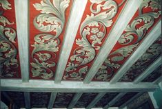 an ornate ceiling with red and white paint