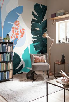 a living room with a large wall mural in the corner and a chair next to it