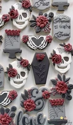 decorated sugar cookies with skulls and roses on them are arranged in the shape of hearts