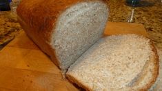 a loaf of bread sitting on top of a wooden cutting board