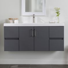 a bathroom vanity with a mirror above it