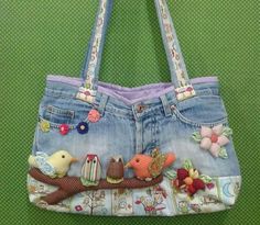 a handbag made out of old jeans with birds and flowers on the front pocket