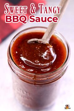 sweet and tangy bbq sauce in a glass jar with a wooden spoon on top