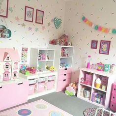 a child's room with pink furniture and toys