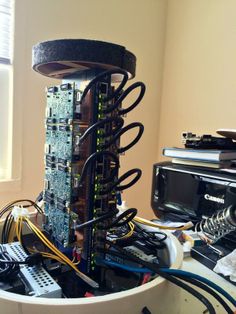 an electronic device is sitting on top of a table with wires and other equipment around it