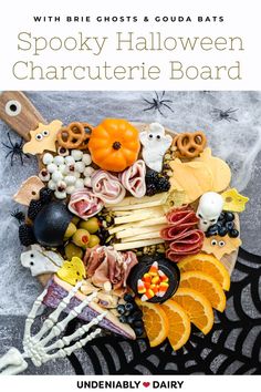 spooky halloween charcuterie board with oranges, blackberries and candy