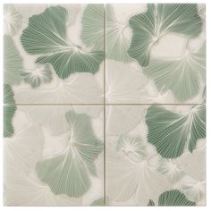 green and white tiles with large leaves on them