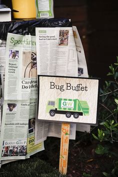 a bunch of newspapers are stacked on top of each other with a sign that says bug buffet