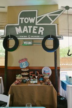 there is a sign that says town mater on the side of the table with other items