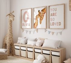 a room with two giraffes hanging on the wall and some storage bins