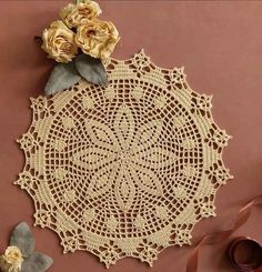 a crocheted doily with flowers on it