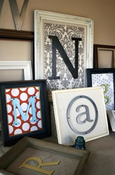 some framed pictures and letters are on the table next to each other, including one letter