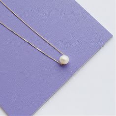 A beautiful, dainty floating pearl necklace made of 9ct yellow gold. The pearl is a genuine cultured freshwater pearl. It is 8mm in diameter and has been hand drilled to float on a 0.75mm delicate 9ct gold chain. Chain length can be chosen from the drop box at checkout. Pearl is the birthstone for June and so this stunning necklace would make the perfect gift for a June baby. Pearl also represents the 30th anniversary of a special bond and can be given as an anniversary present to signify the be Minimalist 14k Gold Necklace With Pearl Pendant, Minimalist Yellow Gold Charm Necklace With Pearl Chain, Minimalist 14k Gold Pearl Necklace With Pearl Charm, Dainty 14k Gold Pearl Drop Necklace, Minimalist 14k Gold Pearl Necklace Gift, Minimalist 14k Gold Necklace With Pearl Charm, White Pearl Necklace With Delicate 14k Gold Chain, Minimalist Yellow Gold Pearl Necklace With Round Pendant, Dainty Pearl Necklace With Delicate Chain And Round Pendant