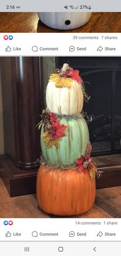 three different pumpkins stacked on top of each other in front of a fire place