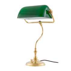 a green desk lamp with a gold base and a white light on the top of it