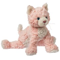 a pink stuffed cat sitting on the ground