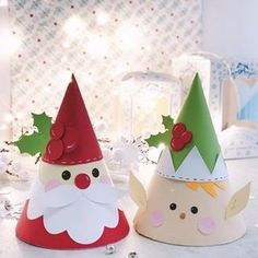 two paper hats with christmas decorations on them