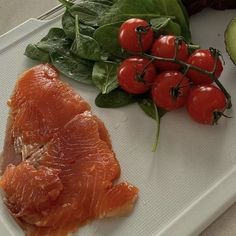 the fish is prepared and ready to be eaten on the plate with spinach leaves