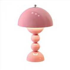 a pink lamp sitting on top of a table