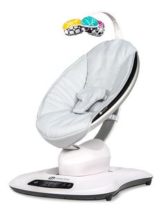 a white baby seat sitting on top of a scale with an object in the background