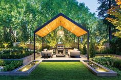 an outdoor living area is lit up with lights and lighting in the middle of it