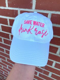 "EMBROIDERED SAVE WATER, DRINK ROSE BALLCAP These super cute dad style baseball caps are 100% embroidered with \"Save Water, Drink Rose\" text Stitching in hot pink thread -- Choose ballcap color of your choice from our chart! Caps are fully adjustable All items are handmade to order with most items being customized. For this reason, we do not accept returns or exchanges. Cancellations are accepted on a case-by-case basis and are only available for orders that have not begun processing" Casual Pink Fitted Hat With Flat Brim, Fun Dad Cap For Spring, Casual Pink Flat Brim Baseball Cap, Pink Baseball Cap For Baseball Season, Pink Curved Bill Hat For Baseball Season, Pink Casual Snapback Hat For Baseball Season, Casual Pink Snapback Hat For Baseball Season, Spring Baseball Cap With Letter Print And Short Brim, Spring Dad Hat With Letter Print And Flat Brim