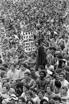 a crowd of people are gathered together and holding signs that read love your animal friend them